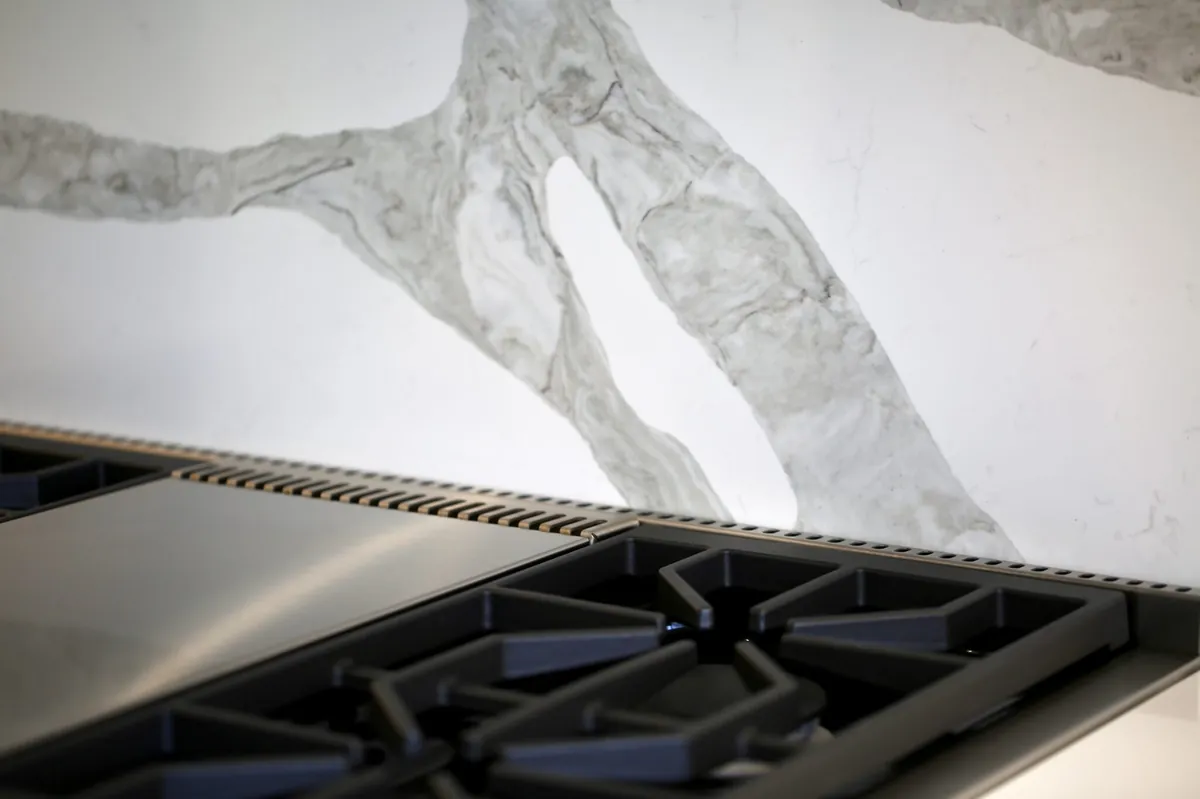 Glossy white cabinetry and stainless steel fixtures